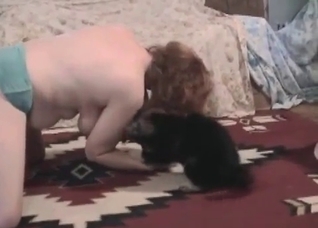 Awesome black puppy plays with a hot redhead
