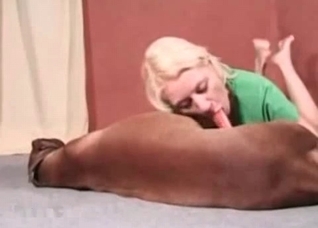 Bleached cutie is sucking a dog dick
