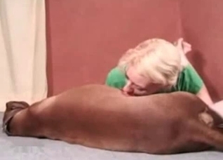 Bleached cutie is sucking a dog dick